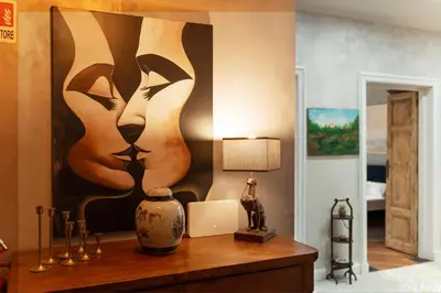 a bedroom with a painting of cats on the wall at RomanticRome, elegant apartment in Trastevere district in Rome