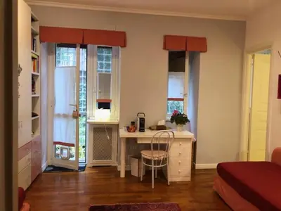 a room with a desk with a chair and windows at Camera Trastevere 2 in Rome