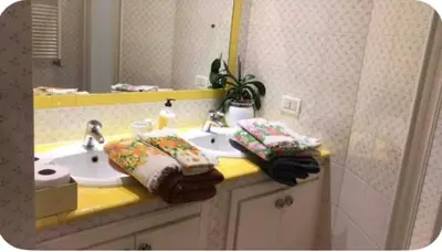 a bathroom with two sinks and a mirror at Camera Trastevere 2 in Rome