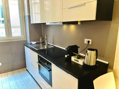 a kitchen with a sink and a counter top at Monti Hideaway - Walk to Colosseum & Forum in Rome