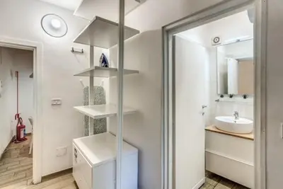 a white bathroom with a sink and a mirror at Petite Fleur in Rome