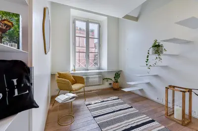 a living room with a chair and a window at Skylife Monti's Wonders - Colosseum Gem in Rome