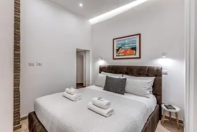 a bedroom with a bed with two towels on it at Loft in the Ghetto 2 in Rome