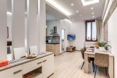a kitchen and living room with a table and a dining room at Loft in the Ghetto 2 in Rome