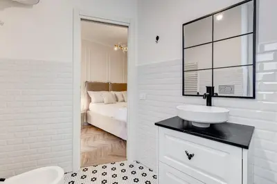 a white bathroom with a sink and a bed at Vatican Design Apartment - NEW! in Rome