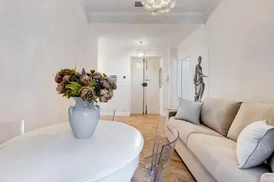 a living room with a vase of flowers on a table at Vatican Design Apartment - NEW! in Rome
