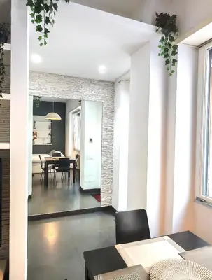 a living room with a table and a dining room at Piramide Charming Flat e Terrace in Rome