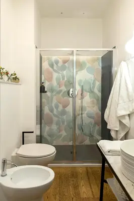 a bathroom with a shower and a toilet and a sink at Colosseum - Diana's Design Apartment in Rome