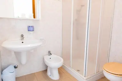 a bathroom with a sink and a toilet and a shower at Villa Santa Emerenziana in Rome