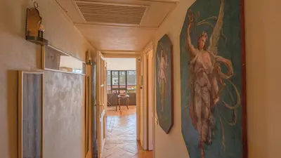 a hallway with a large painting on the wall at EasyTopStay - Charme and View in the Heart of Rome in Rome