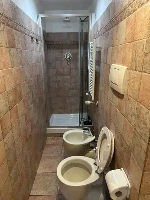 a bathroom with a toilet and a sink and a shower at 3 coins trastevere station in Rome