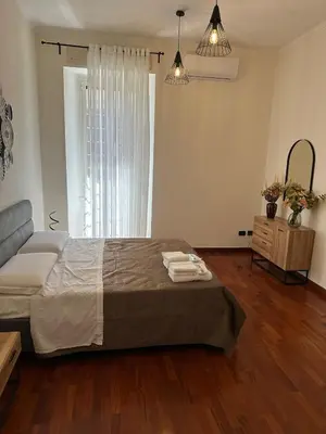 a bedroom with a bed with two towels on it at 3 coins trastevere station in Rome