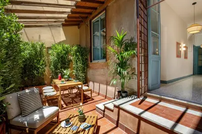 an outdoor patio with a table and chairs at Daplace - Serena Apartment in Rome