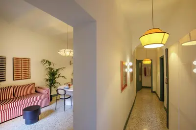a hallway with a red couch and a table at Daplace - Serena Apartment in Rome