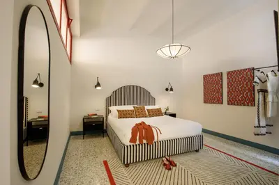 a bedroom with a large bed and a mirror at Daplace - Serena Apartment in Rome