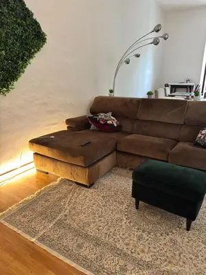 a living room with a brown couch and a ottoman at Villa Classical Roman Art - Monteverde with Garden in Rome