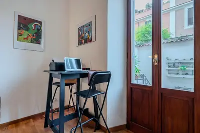 a desk with a laptop computer on it in a room at Villa Classical Roman Art - Monteverde with Garden in Rome