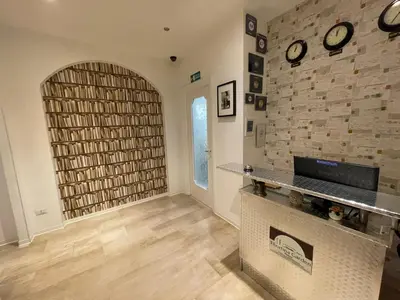 a living room with a fireplace and a stone wall at B&B Tiburtina Garden in Rome