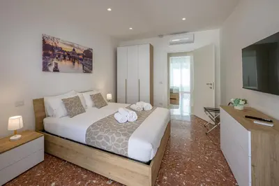 a bedroom with a large bed with towels on it at Luxury Domus- Metro Malatesta in Rome