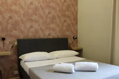 a bedroom with a bed with two towels on it at Rooms Piramide 1 in Rome