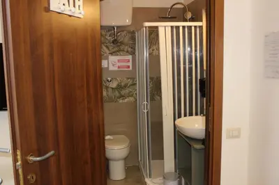 a small bathroom with a toilet and a sink at Rooms Piramide 1 in Rome