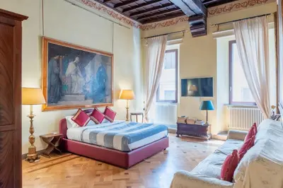 a bedroom with a bed and a couch at Roman Charme Spagna in Rome