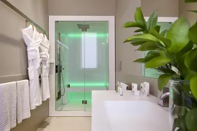 a bathroom with a shower and a sink and a mirror at Crossing Condotti in Rome