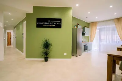 a living room with green walls and a potted plant at 4 Seasons Roma Trastevere in Rome