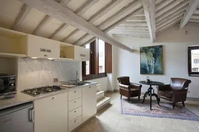 a kitchen with a stove and a table with chairs at Laurina F1 Studio with Panoramic Terrace - LOCAPPART in Rome