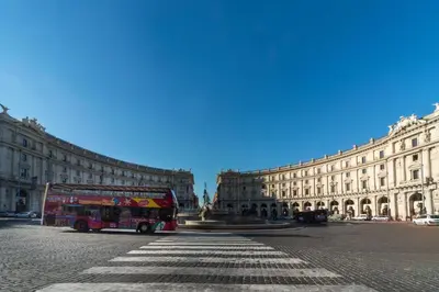 a double decker bus parked in front of a building at RELAX Palace in Rome
