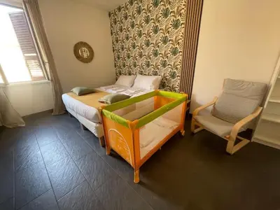 a small bedroom with a bed and a chair at Appartamento Boho a San Lorenzo ,quartiere della street art in Rome