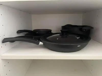 two pots and pans sitting on a shelf at Appartamento Boho a San Lorenzo ,quartiere della street art in Rome