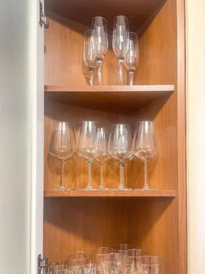 a kitchen with wooden cabinets and a table with chairs at RM555 Elegant apartment in Rome