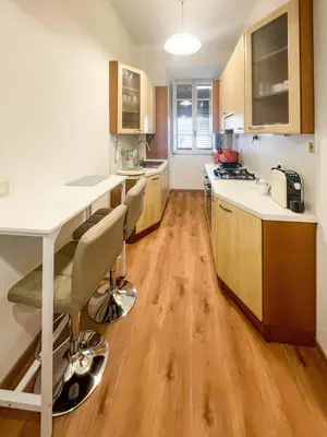 a table with a white plate and glasses on it at RM555 Elegant apartment in Rome