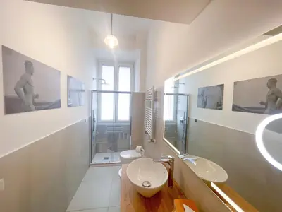 a shower with a hose attached to a wall at RM555 Elegant apartment in Rome
