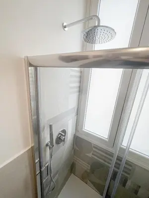 a shower in a bathroom with a window at RM555 Elegant apartment in Rome