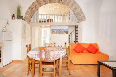 a living room with a table and a couch at La Casetta Aureliana in the center of the capital in Rome