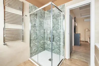 a shower in a bathroom with a glass door at ROMAN DREAM lV in Rome