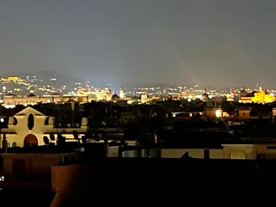 a view of a city skyline at night at Belvedere home in Rome