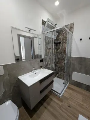 a bathroom with a sink and a shower and a toilet at Maison Maurizio Marconi in Rome
