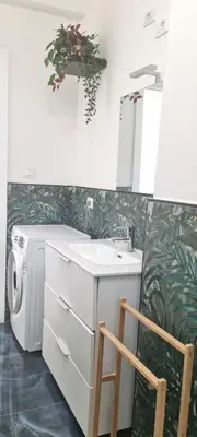 a bathroom with a sink and a washing machine at Appartamento Roma San Giovanni in Rome
