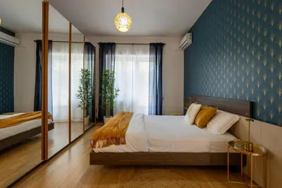 a bedroom with a bed and a blue wall at Maia - Luxury Apartment in Monteverde in Rome