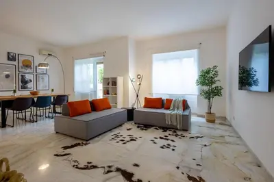 a living room with two couches and a dining room at Maia - Luxury Apartment in Monteverde in Rome