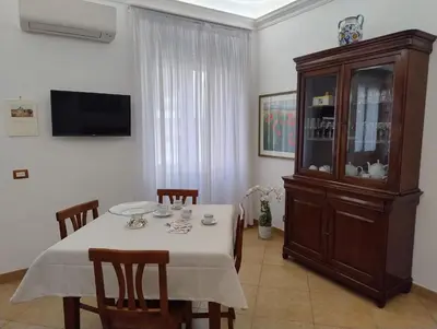 a dining room with a table and a hutch at Alcinque - Casa vacanze in Rome