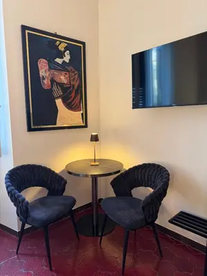 a room with two chairs and a table and a picture at Suite 41 in Rome