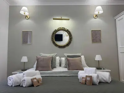 a bedroom with a large bed with a mirror on the wall at Sweet Saint Paul in Rome