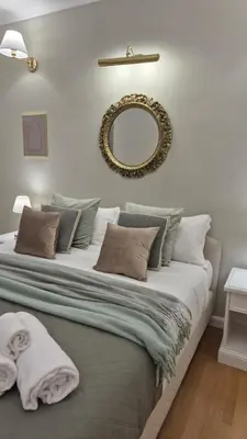 a bedroom with a large bed with a mirror on the wall at Sweet Saint Paul in Rome