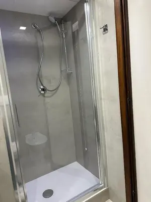a shower with a glass door in a bathroom at Appia Suite in Rome