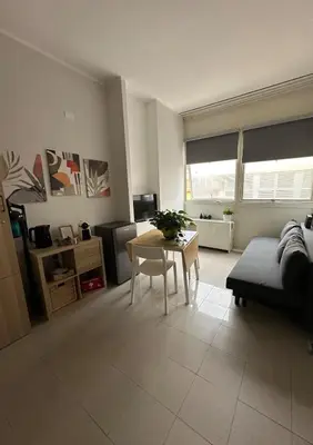 a living room with a table and a couch at Appia Suite in Rome
