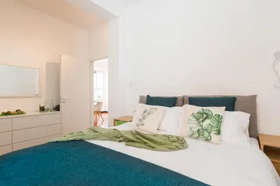 a bedroom with a bed with white and blue at Line 8 House in Rome